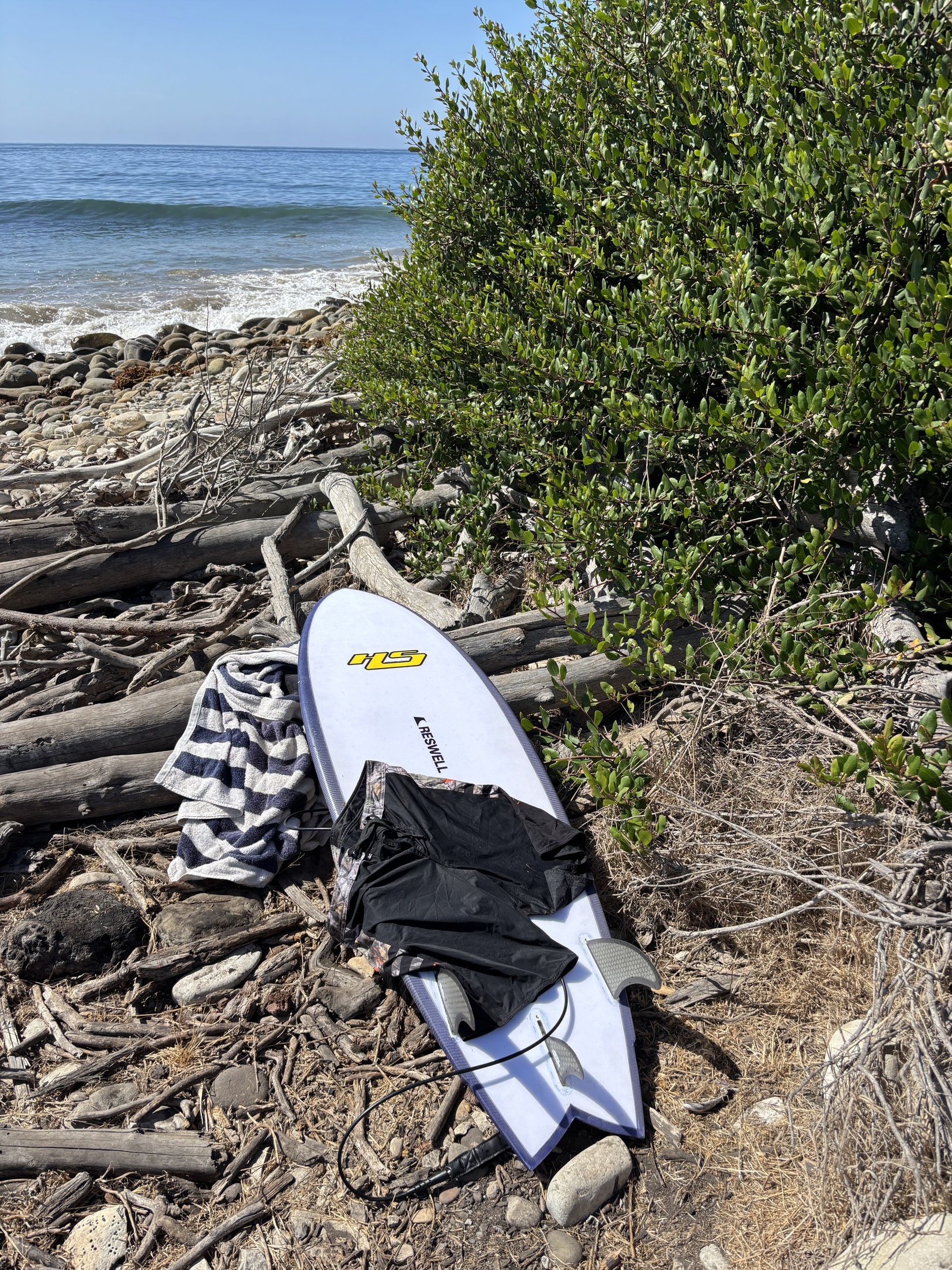 A Hayden Shapes board, towel, and trunks on the rocks between sessions
